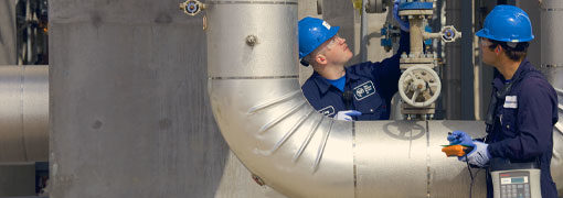 Engineers inspecting pipes for emissions