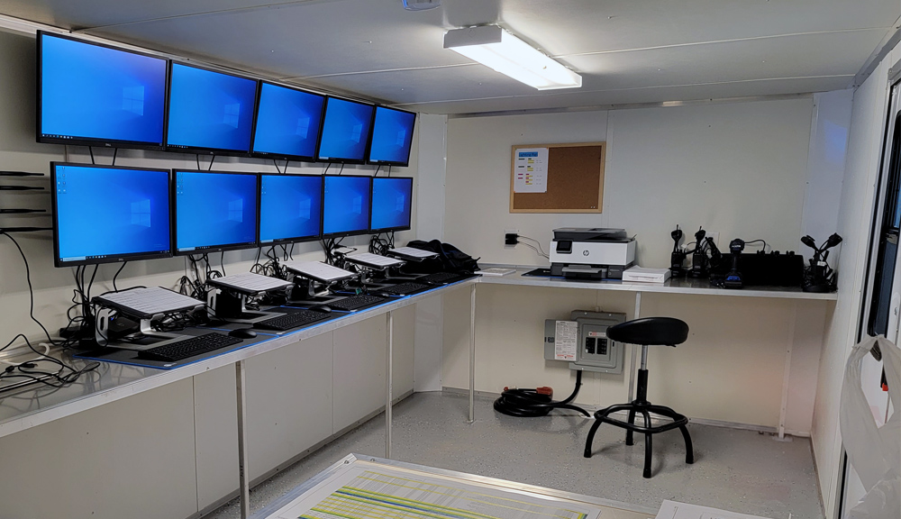 Interior of TEAM’s heat treating mobile command center with multiple monitors and remote process-control workstations.